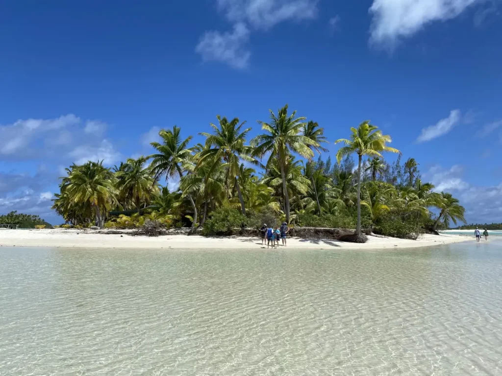 Calm shallow water over white sand in Aitutaki lagoon