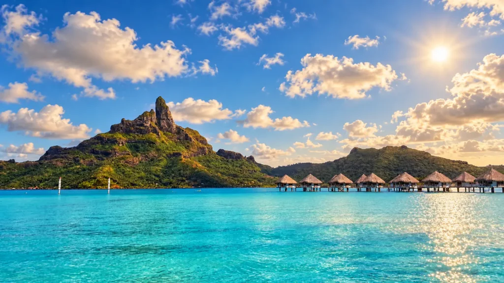 Overwater villa at blue hour with Mount Otemanu in the distance