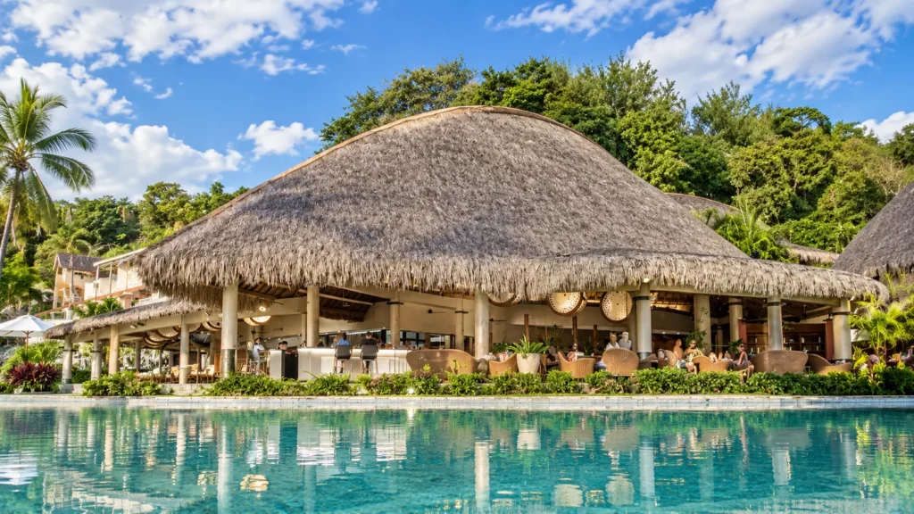 Black-sand beach and pool at Tahiti Pearl Beach Resort, Matavai Bay