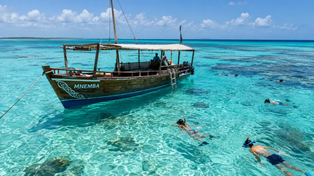 Wooden dhow anchored in the waters near Mnemba Atoll, Zanzibar